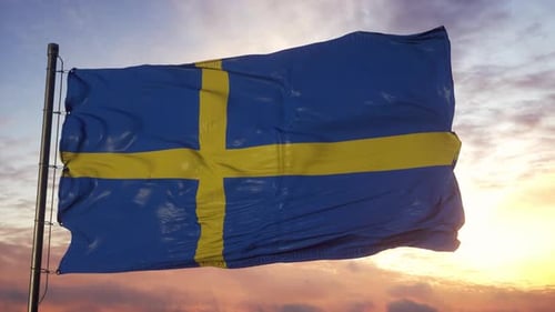 Swedish Flag Waving Against a Dramatic Sunset Sky
