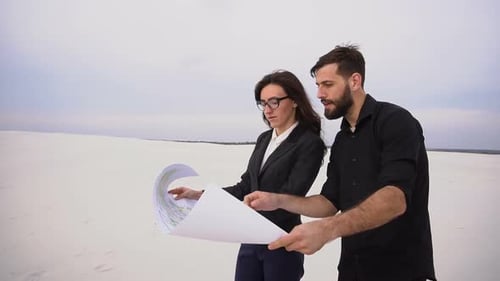 CEO Male and CFO Female Discussing Project of Wind Power Plant in Deserted Place