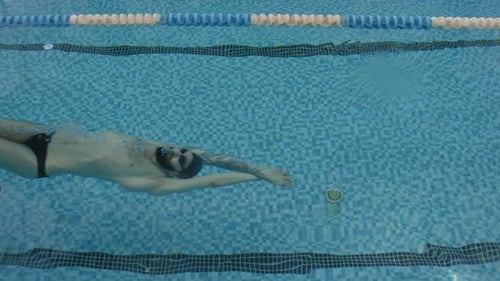Man Swimming with Backstroke in Pool