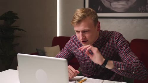 Smiling Businessman Talking on Laptop Video Conference Online at Home Office