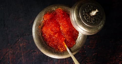A Plate of Red Caviar Slowly Rotates on the Table