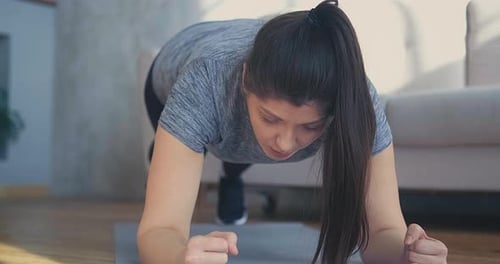 Woman Doing a Plank Exercise at Home