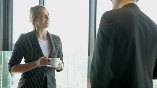 Business Professionals Talking in Modern Urban Workplace