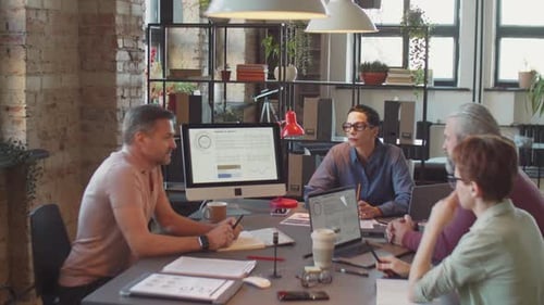 Business People Discussing Project at Office Meeting