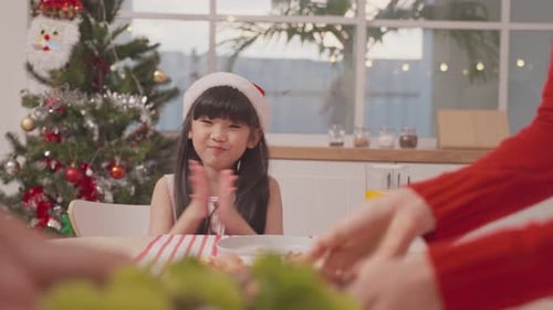 Family Celebrates Christmas Dinner at Home with Joy