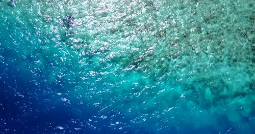 Beautiful birds eye abstract view of a sandy white paradise beach and aqua blue water background in