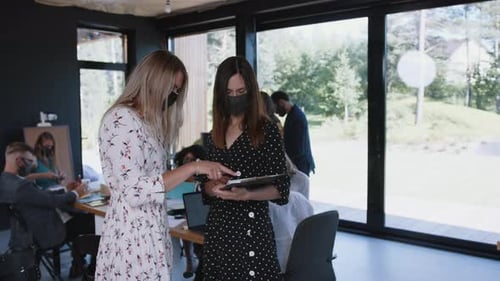 Women in Masks Meet at Modern Office