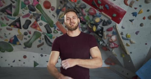 Medium Shot Portrait of a Young Bearded Smiling Climber Crossing Arms