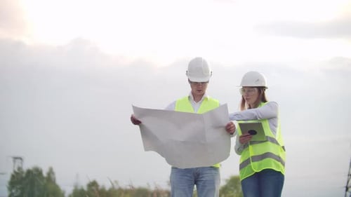 Coworking Engineers with Tablets on Solar Plant