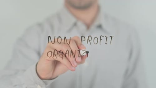 Non Profit Organization Writing on Screen with Hand