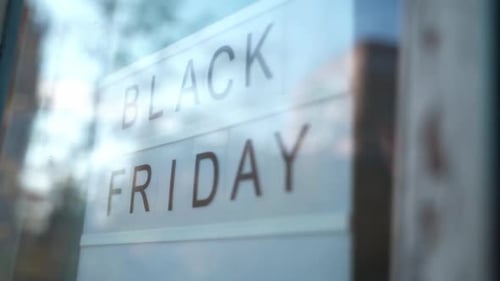 Lightbox Sign Black Friday Behind a Glass Door of the Cafe. Concept Black Friday, Season Sales Time