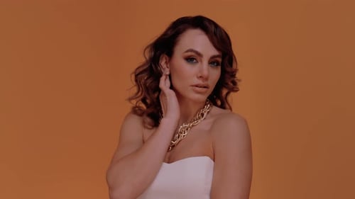 Glamorous Woman with Gold Chain Posing Confidently