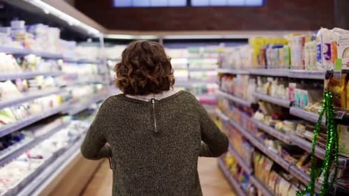Rare View of Happy Excited Woman in Sweater Went Shopping with Trolley Cart Walk By a Row and