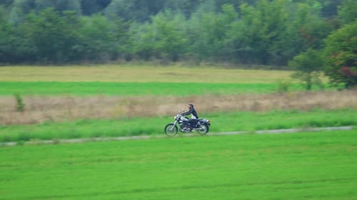 Man riding motorcycle on rural road