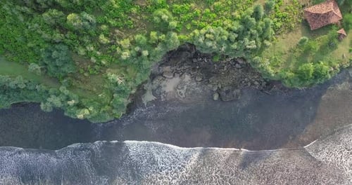 Sliding drone shot of waves hit the cliff. Cliff border with sea. The south coast of Java with the I