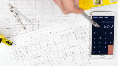 Architects Make Calculations with the Help of a Calculator and Correct Mistakes. Close Up