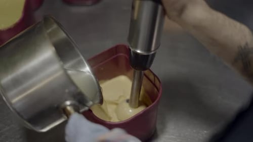 Cream being blended in a container close up