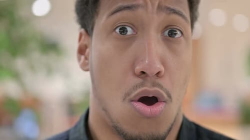 Close Up of Shocked Expression of Young Businessman