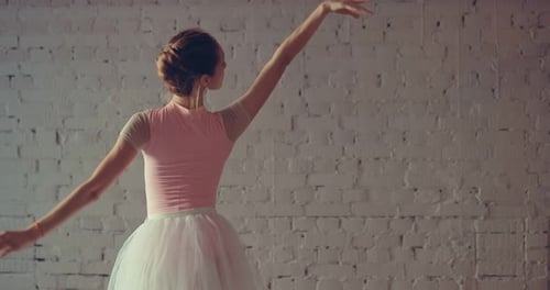 Elegant Ballerina Dances Gracefully in White Studio