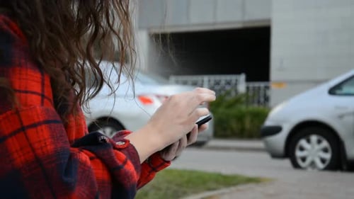 Young Adult Using Tablet in Urban Area