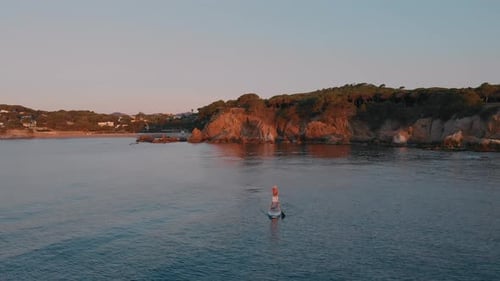 Aerial Drone Shot of Man Paddle Board Near Coast