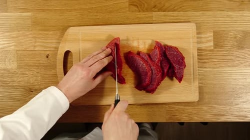 Dicing Fresh Red Meat on Cutting Board