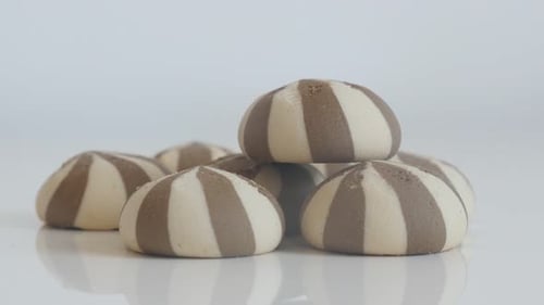 Close-up of tasty bicolor biscuits 4K 2160p 30fps UltraHD tilting footage - Pile of cookies with m