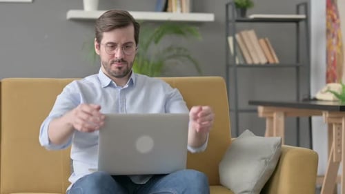 Young Man Closing Laptop Leaving Sofa