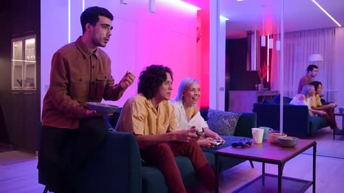 Young Adults Enjoying Video Games Together in Modern Room
