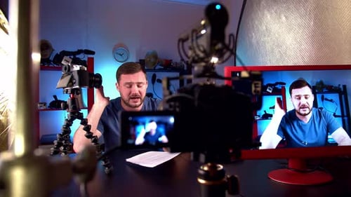 Blogger is Broadcasting in Video Studio with Cameras and Professional Lighting