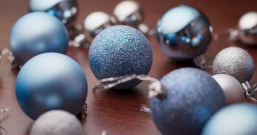Blue and Silver Christmas Baubles on Wooden Surface