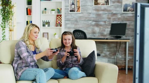 Woman and Girl Play Video Games Together
