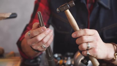 Young Talented Goldsmith Giving a Form To a Ring.