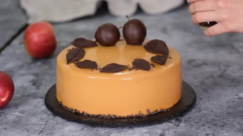 Pastry Chef Decorating the Mousse Cake with Small Chocolate Pieces