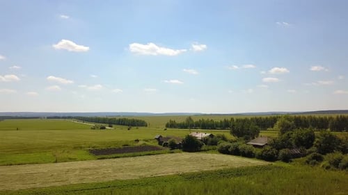 Aerial View of Green Fields and Farmhouses