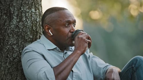 Headshot Portrait Elderly African American Black Man Businessman Sitting Under Tree Resting in City