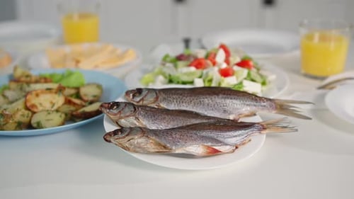 Table set for homemade meal with fish, salad