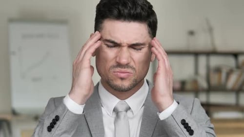 Man Massaging Temples During Headache