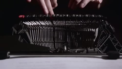 Close Up of Person Typing on Black Typewriter