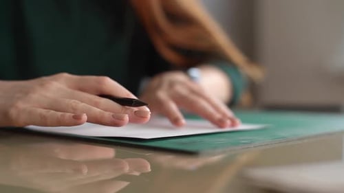 Closeup Hands of Unrecognizable Female Designer Putting White Paper on Green Rubber Cutting Mat and