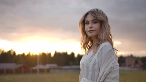 Young Woman Posing in Rural Field at Sunset