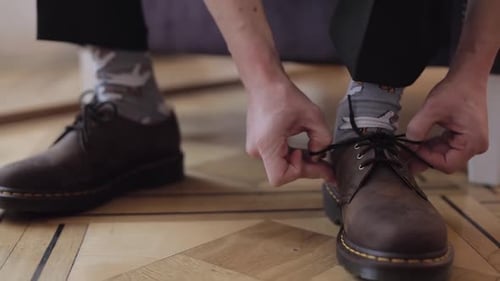 Closeup Hands of Man Groom Adjusting Wearing Putting His Wedding Shoes in Hotel Room Near Window