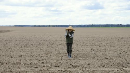 Boy with a Shovel Going in the Field