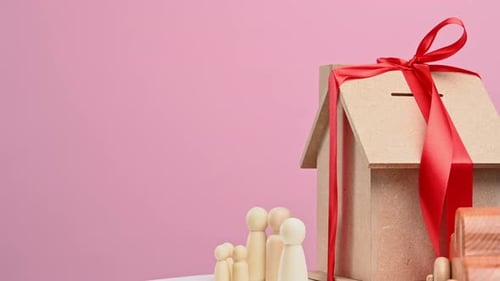 wooden house and car with miniature family figures, mortgage