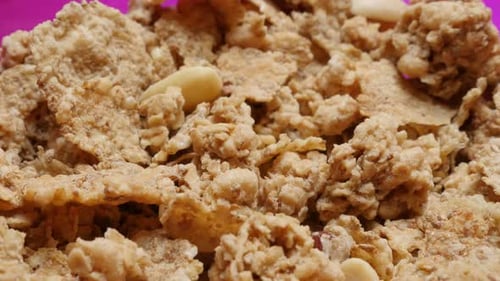 Tasty cereals in the bowl crunchy breakfast 4K 2160p 30fps UltraHD slow tilt video - Tilting on hea