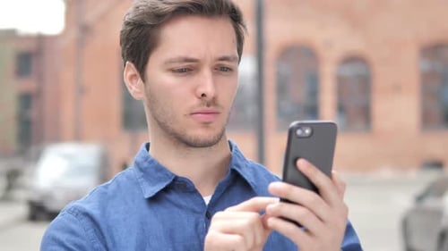 Young Adult Using Smartphone Outdoors