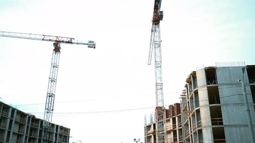 Buildings and Cranes Constructing New Urban Building