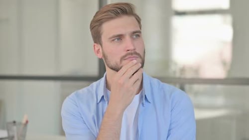 Portrait of Pensive Young Creative Man Thinking