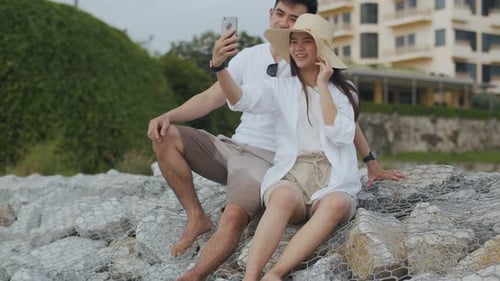 Smiling Couple Taking Selfie at the Beach