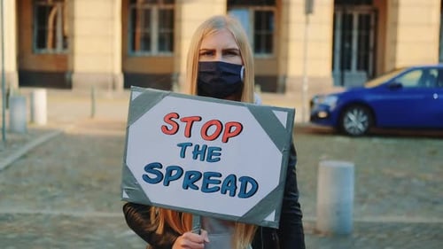 Blonde Person Holding Stop the Spread Sign